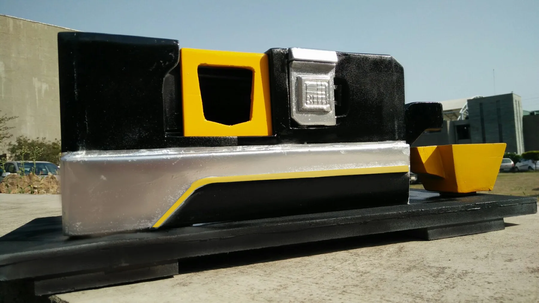 Side view of a painted black, silver, and yellow physical LT-20 appearance model.