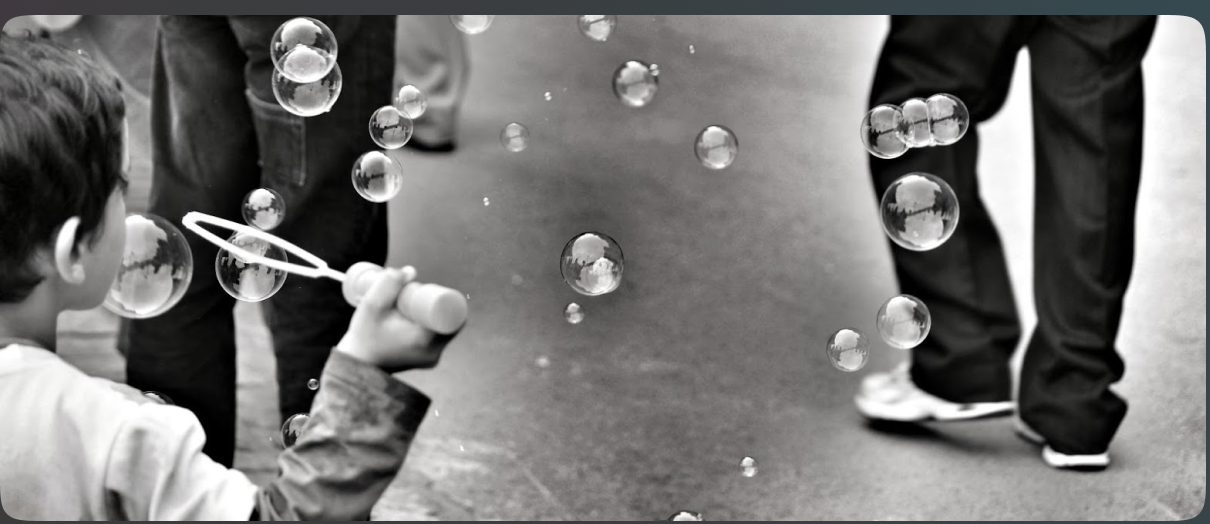 Black and white street photograph with bubbles floating through a walkway.